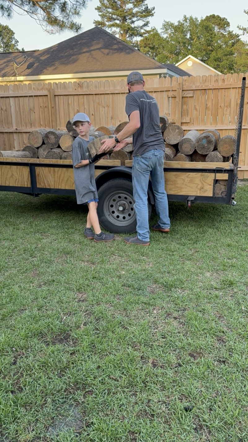Yosef unloading rounds to stack for a customer, with Dad lending a hand.